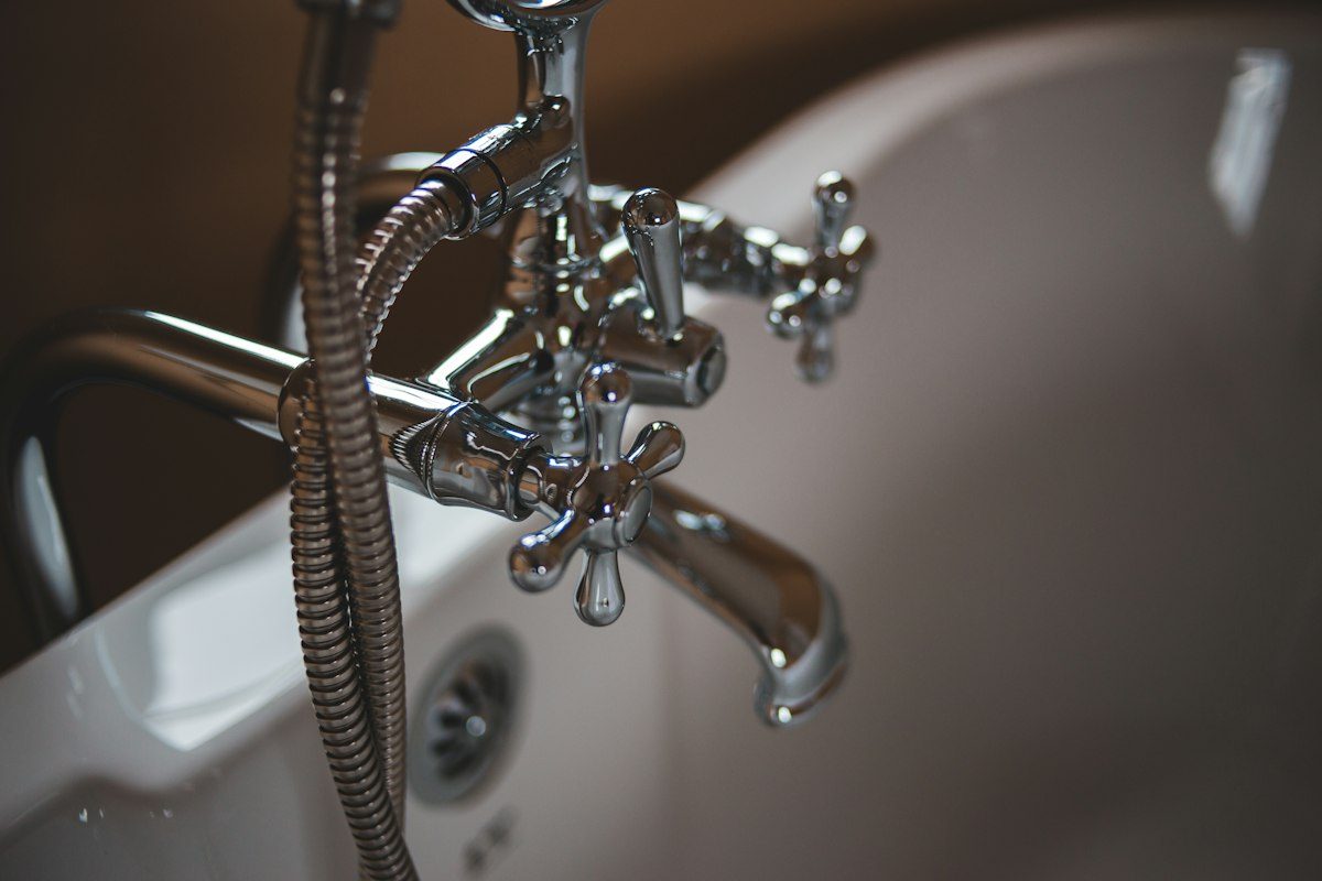 Polished chrome bathtub faucet in a clean white tub